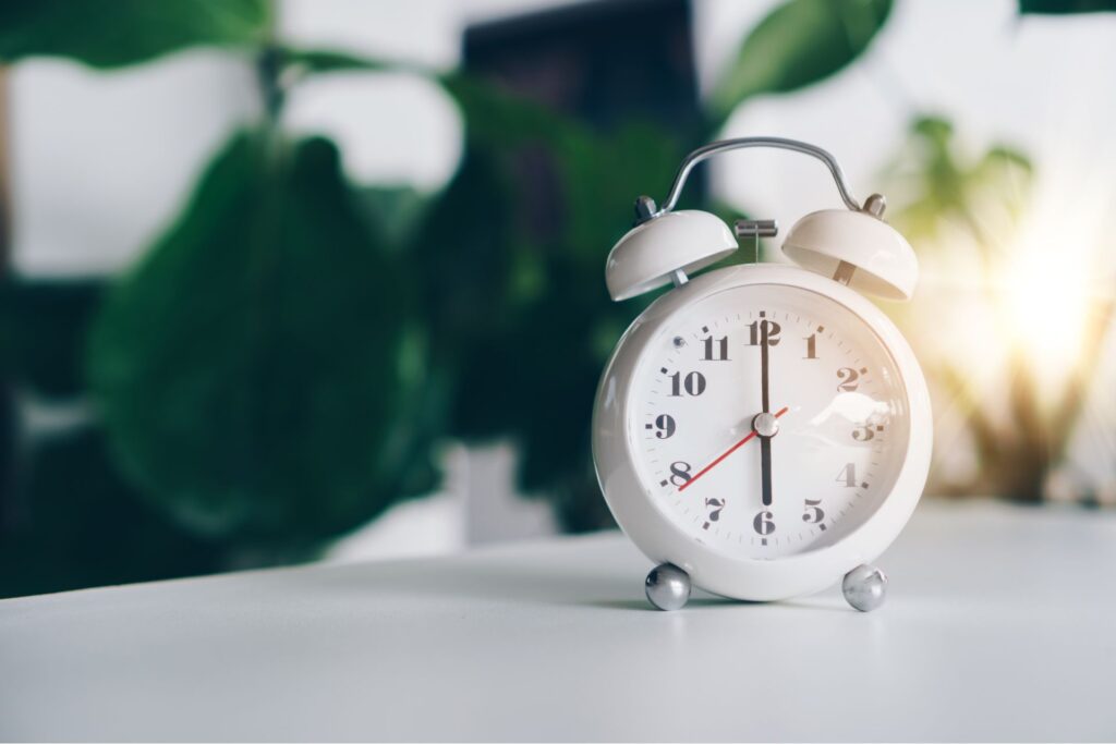 healthy morning habits - wake up early. a clock set at 6 AM