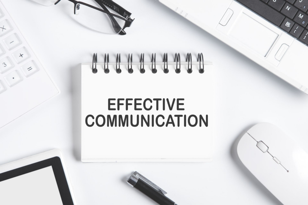how to be better at communicating - notebook in a desk with "effective communication written on it." 