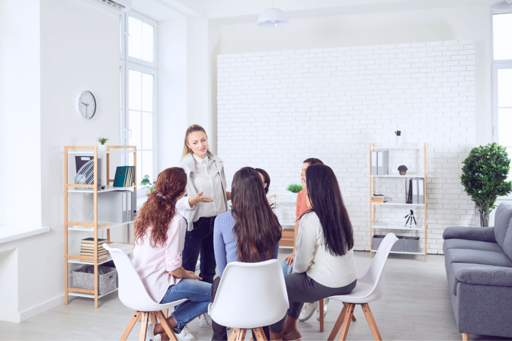how to delegate effectively - image of a a female leader talking to her team